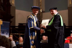 A graduate award winner with UCEM Principal, Ashley Wheaton, at the December 2019 UCEM Graduation