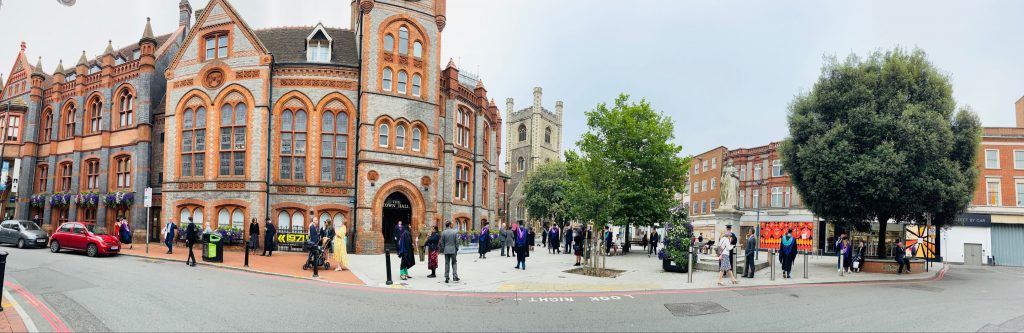 Panoramic view of graduates outside the town hall