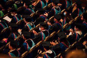 Seated graduands applauding