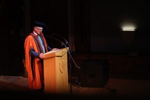 Dr Stephen Jackson speaking to the graduands from the stage