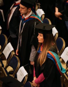 Graduands stood by their seats