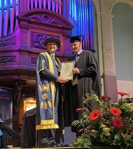 A graduand receives his award