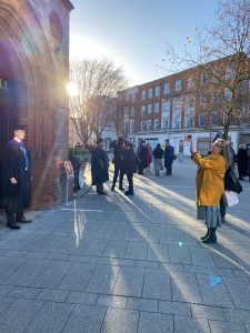 A guest takes a photo of a graduand