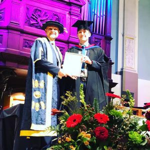 A graduand receives his award