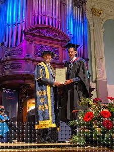 A graduand receives his award