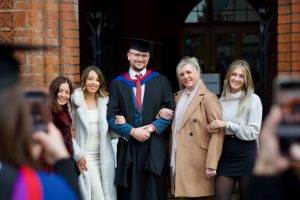 A graduand with his family