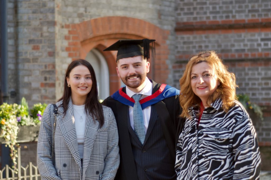 Graduand with his family