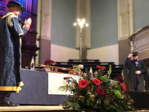 A graduand walks across the stage