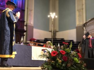 Graduate doffing mortar board