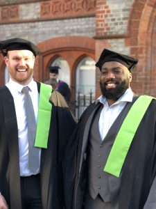 Two graduates laughing