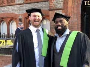 Two graduands smiling broadly