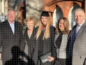 Graduate and family pose for a photo