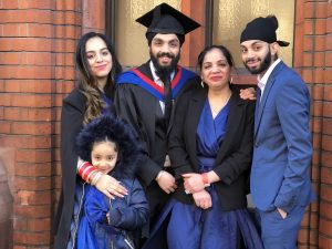 Graduate and family pose for a photo