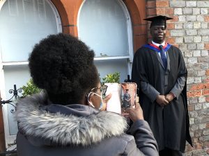 A guest takes a photo of a graduand