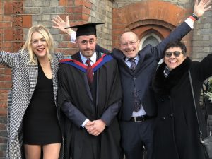 Graduate and family pose for a photo