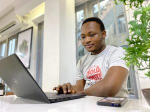 Man browsing on laptop on desk